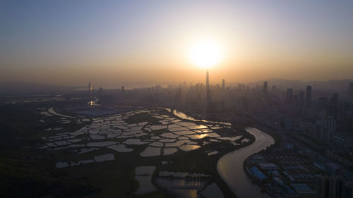 High angle view of city at sunset