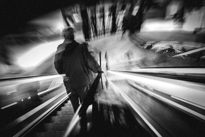 Rear view of man standing on train