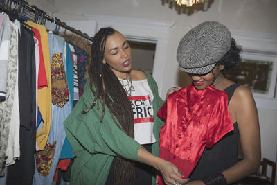 Two young women choosing an outfit