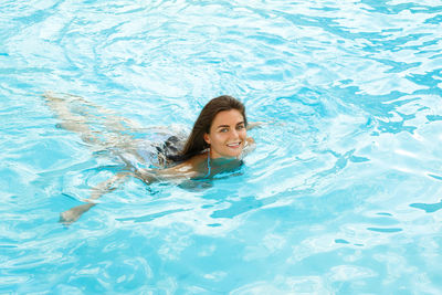 Portrait of woman swimming in pool