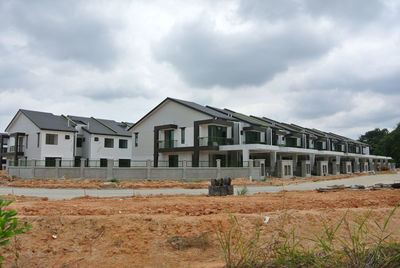 Houses on field against sky