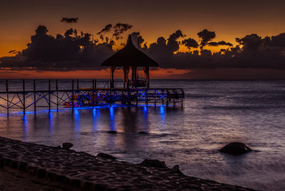 Silhouette of pier at sunset
