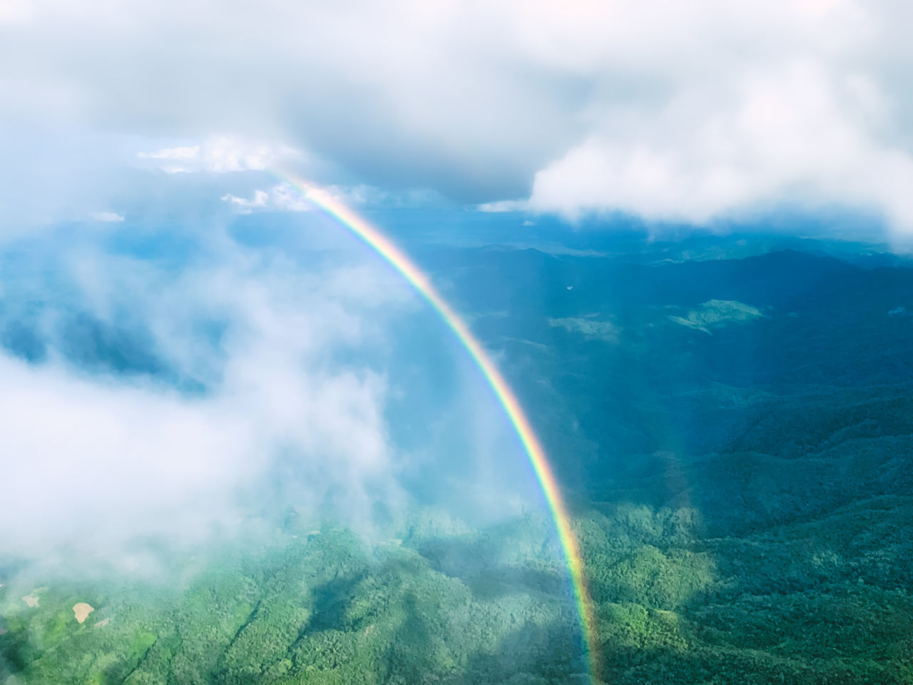 LOW ANGLE VIEW OF RAINBOW IN SKY