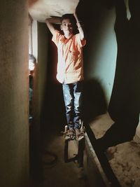 Portrait of boy standing in corridor