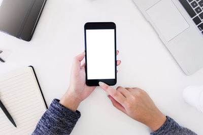 Midsection of man using mobile phone