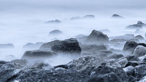 Rocks at beach during winter