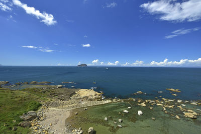 Scenic view of sea against blue sky