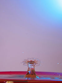 Close-up of water splashing against blue sky