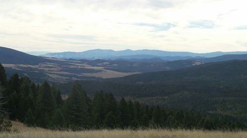 Scenic view of mountains against cloudy sky