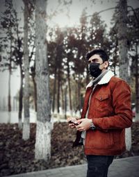 Young man wearing mask standing outdoors