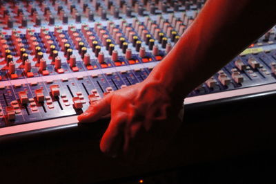 Cropped hand of man using sound recording equipment