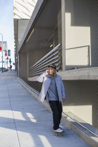 Full length of woman walking on building in city