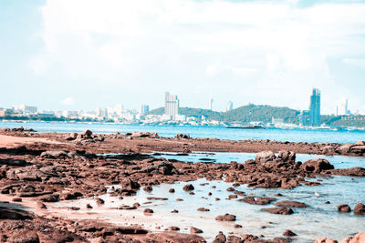 Panoramic view of sea and buildings against sky