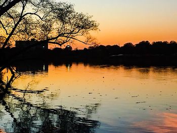 Scenic view of lake against sky at sunset