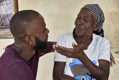 Mozambique, maputo, portrait of grandmother with grandson