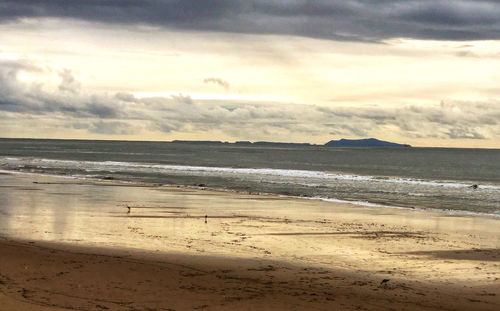 Scenic view of beach against sky