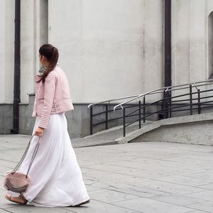 Full length of woman standing by railing