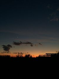 Silhouette landscape against sky at sunset