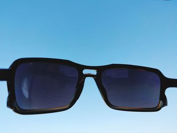 Reflection of sunglasses against clear blue sky