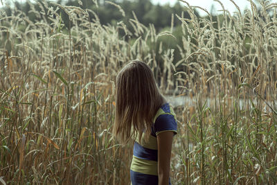 Woman standing amidst plants