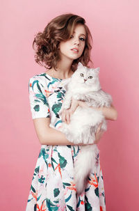 Young woman holding a horse