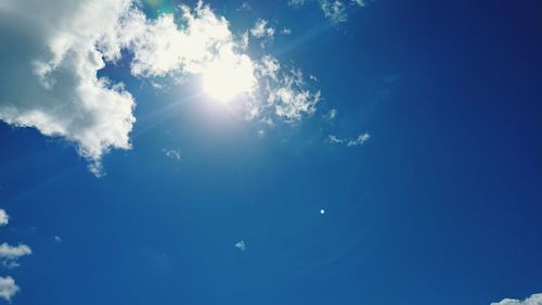 Low angle view of moon in blue sky