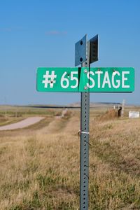 Low angle view of road sign against clear sky