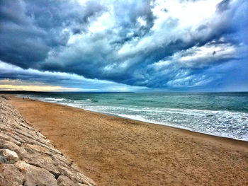 Scenic view of sea against cloudy sky