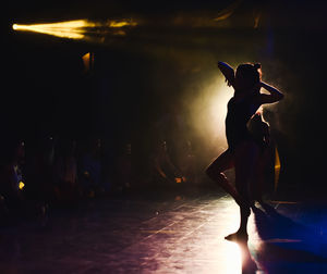 Rear view of woman standing at night