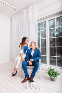 Couple sitting on sofa at home