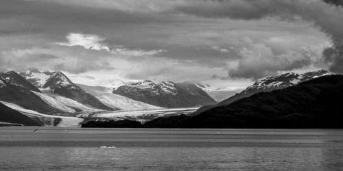 Scenic view of mountains against cloudy sky