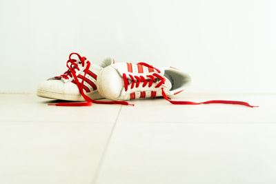 Close-up of shoes on floor against white background