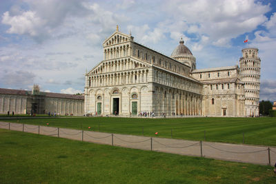 Cathedral of the pisa tower on the grass of piazza dei miracoli in tuscany