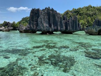 Scenic view of rock formation in sea against sky in misool raja ampat island indonesia 