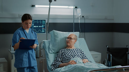 Nurse examining patient in hospital