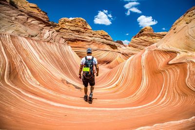 Rear view of man standing at the wave