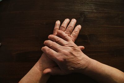 Close-up of hands on table