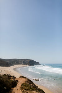 Scenic view of beach against clear sky