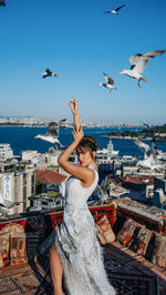 Rear view of woman looking at sea against sky