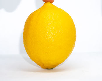 Close-up of orange slice against white background