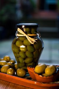 Close-up of olives in jar on table