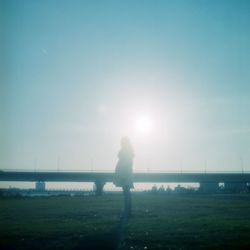 Silhouette of woman standing on grass