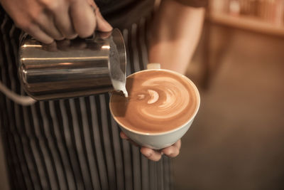 Hand holding coffee cup