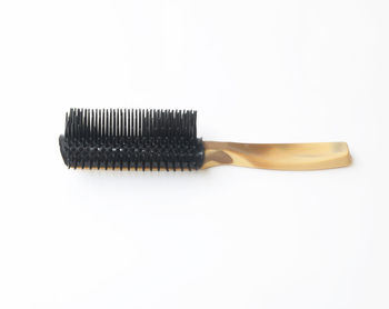 Close-up of hairbrush against white background