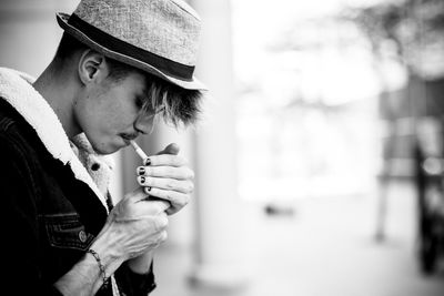 Close-up of man smoking cigarette outdoors