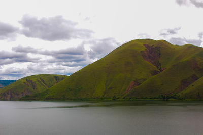 Scenic view of lake and mountains against sky