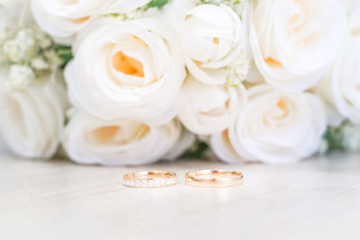 Close-up of wedding rings on table