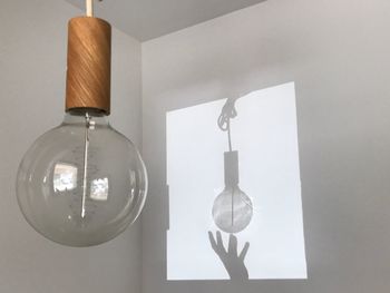 Close-up of light bulb hanging at home