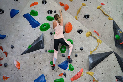 Woman training at bouldering gym. active recreation, sports exercises