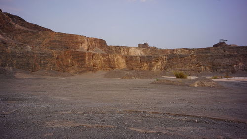 Rock formations on landscape against clear sky